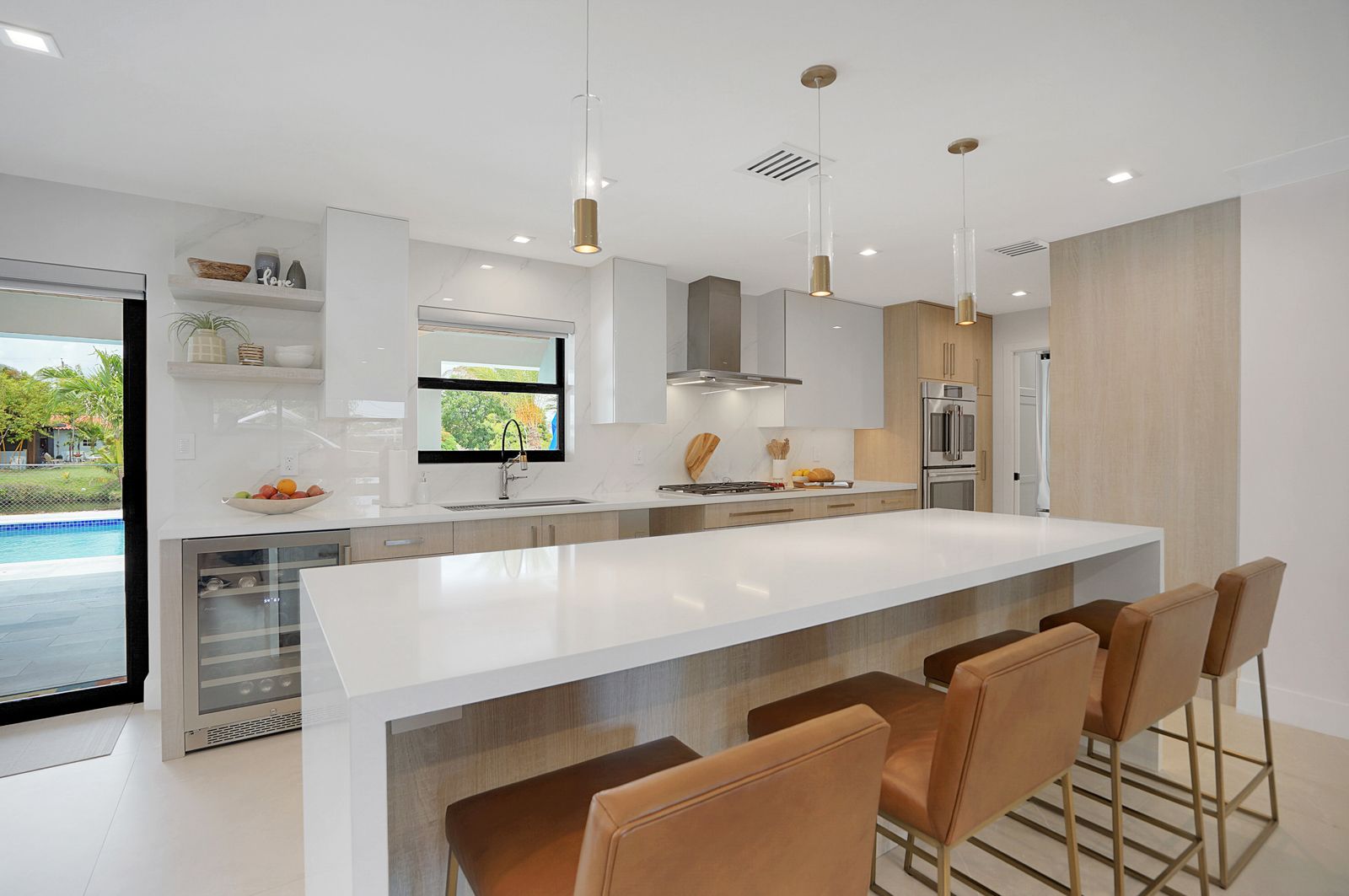 Kitchen with Long White Kitchen Island in Pinecrest, Palmetto Bay, Coral Gables, Ocean Reef, Miami Lakes, and Brickell